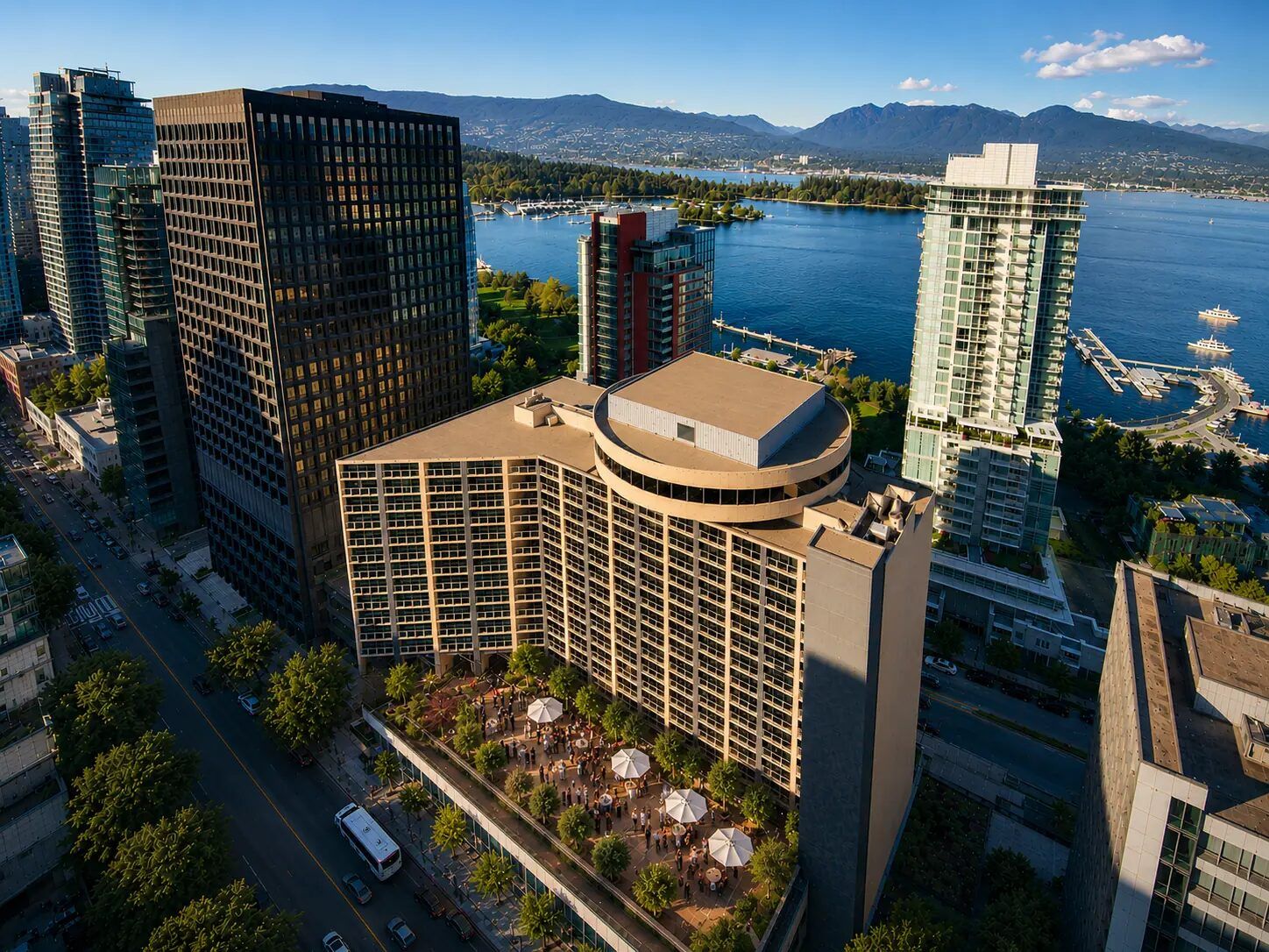 Aerial view of Pinnacle Hotel Harbourfront and its terrace, with Coal Harbour and the North Shore mountains behind