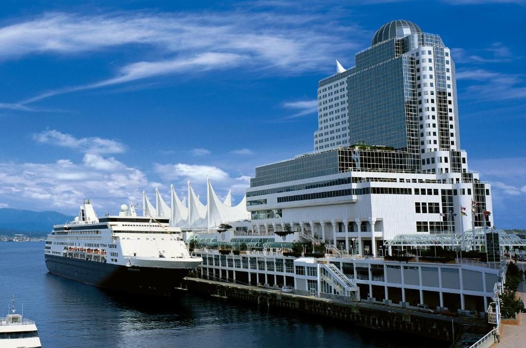 Pan Pacific Vancouver at Canada Place, with its white sails and a cruise ship at the pier
